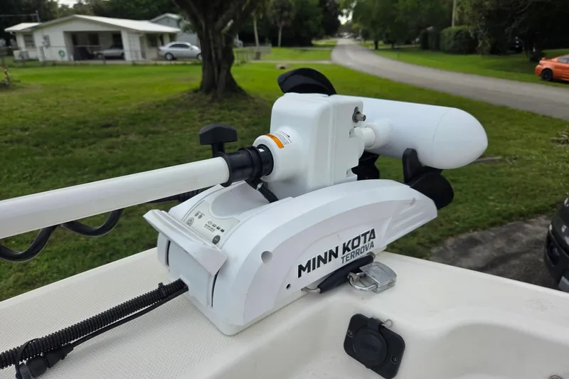 Slide: The Image of Minn Kota Terrova motor on 2023 Mako Pro Skiff 19 CC boat, parked in residential area. - 30