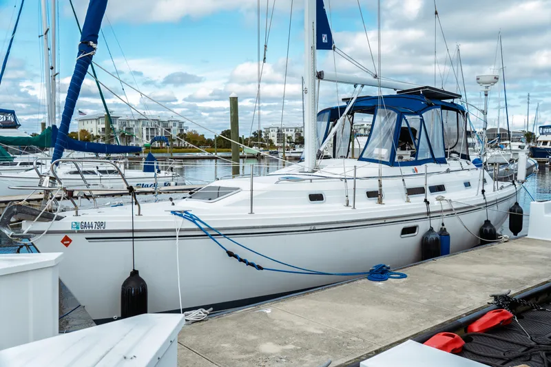 Slide: The Image of 1994 Catalina 38 CC sailboat docked at marina under cloudy sky. - 1