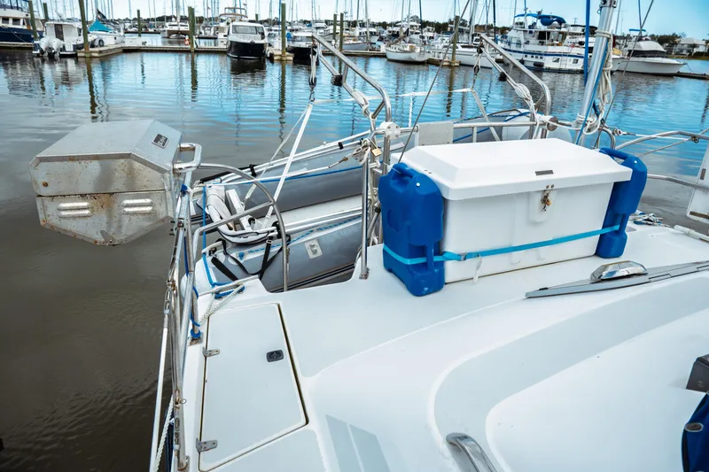 Slide: The Image of 1994 Catalina 38 CC sailboat docked at marina with storage box on deck. - 10