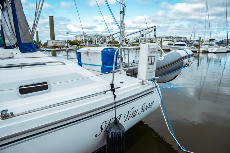 Slide: The Image of Catalina 38 CC 1994 sailboat docked in marina with inflatable dinghy. - 11