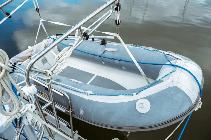 Slide: The Image of Inflatable dinghy on Catalina 38 CC sailboat, 1994 model, secured with ropes. - 12