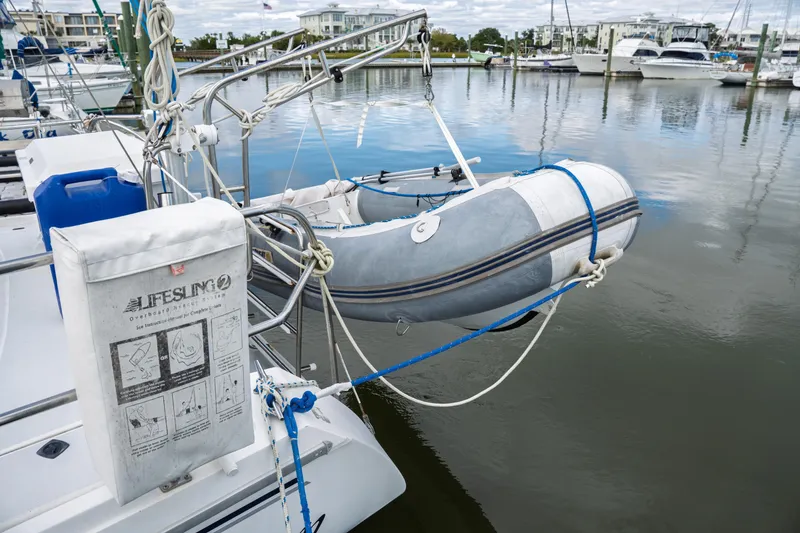 Slide: The Image of Catalina 38 CC 1994 sailboat with dinghy and Lifesling rescue system at marina. - 14