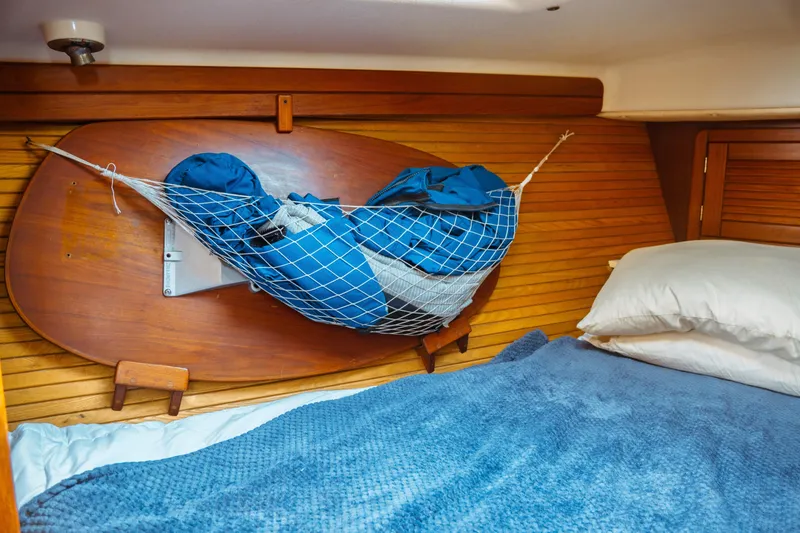 Slide: The Image of Cozy cabin interior of 1994 Catalina 38 CC sailboat with netted storage and bedding. - 17