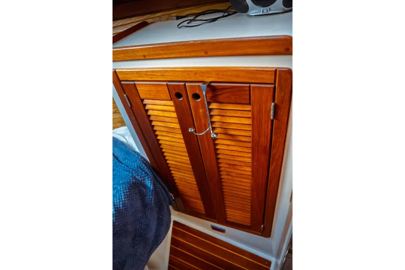 Slide: The Image of Wooden cabinet door inside a 1994 Catalina 38 CC sailboat cabin. - 18