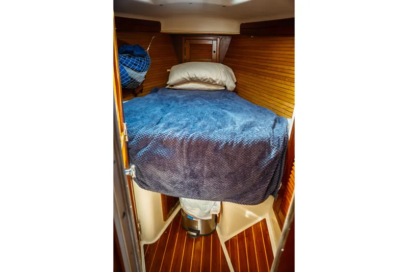 Slide: The Image of Cozy cabin interior of 1994 Catalina 38 CC sailboat with blue bedding. - 19
