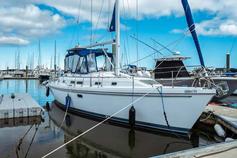 Slide: The Image of 1994 Catalina 38 CC sailboat docked at marina under blue sky. - 2