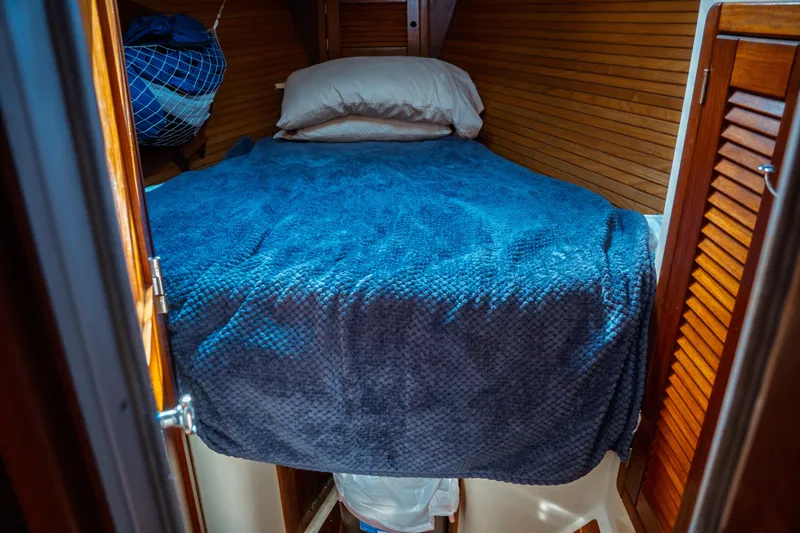 Slide: The Image of Cozy cabin bed in 1994 Catalina 38 CC sailboat with blue blanket. - 20