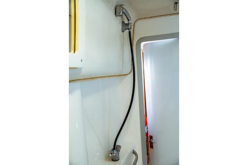 Slide: The Image of Shower area in 1994 Catalina 38 CC sailboat, featuring a handheld showerhead. - 21