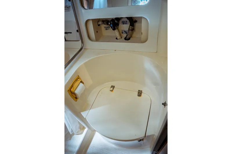 Slide: The Image of 1994 Catalina 38 CC yacht bathroom with storage compartment and plumbing access. - 24