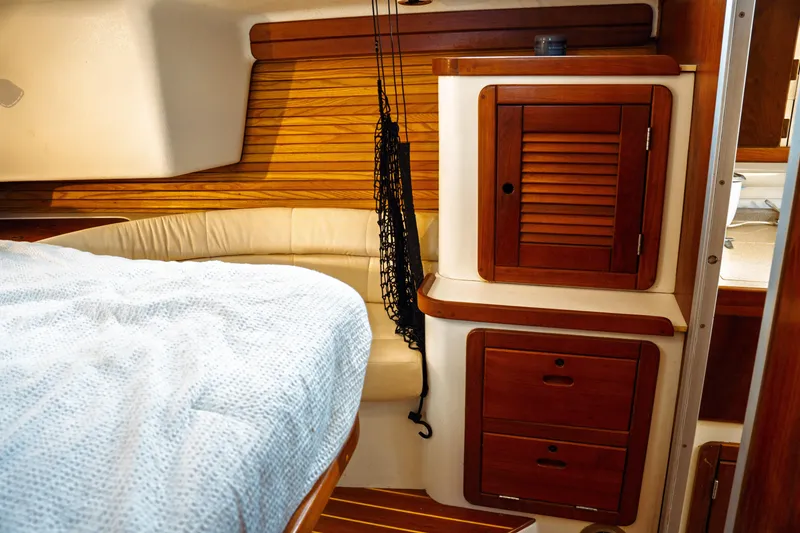 Slide: The Image of Interior of 1994 Catalina 38 CC sailboat with wooden cabinetry and cozy seating. - 25