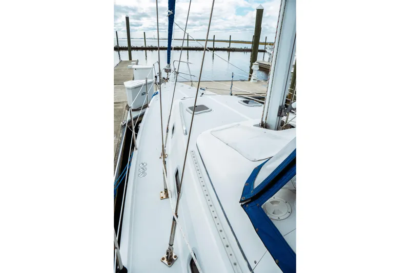 Slide: The Image of 1994 Catalina 38 CC sailboat docked at marina, showcasing deck and rigging. - 3