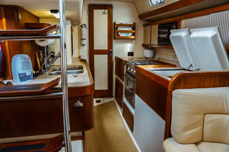 Slide: The Image of Interior of 1994 Catalina 38 CC sailboat with kitchen and seating area. - 31
