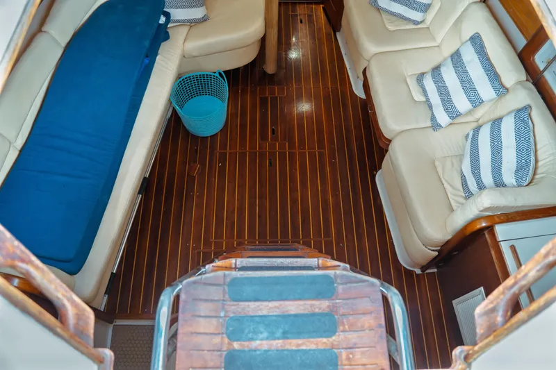 Slide: The Image of Interior of 1994 Catalina 38 CC yacht with wooden flooring and cushioned seating. - 38