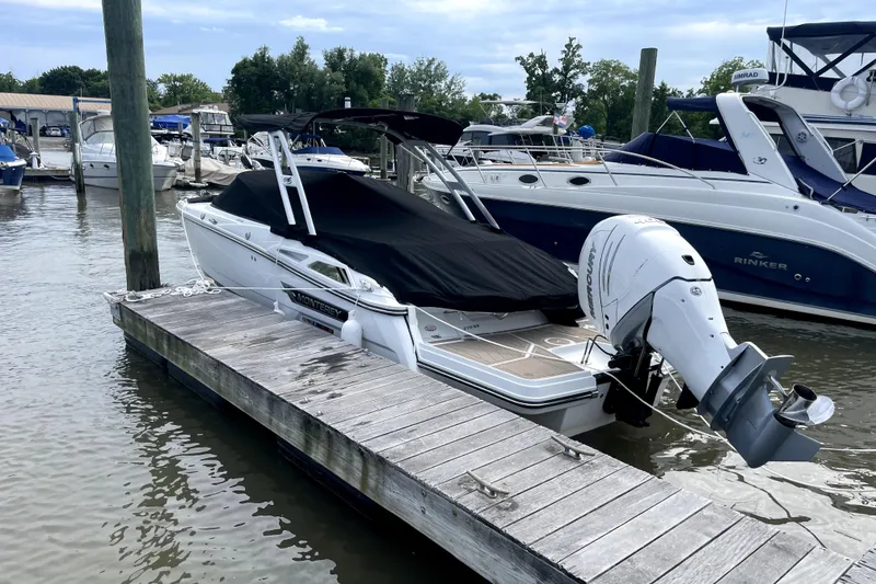 The Image of 2023 Monterey 275SS Super Sport boat docked at marina with cover and outboard motor. - 0