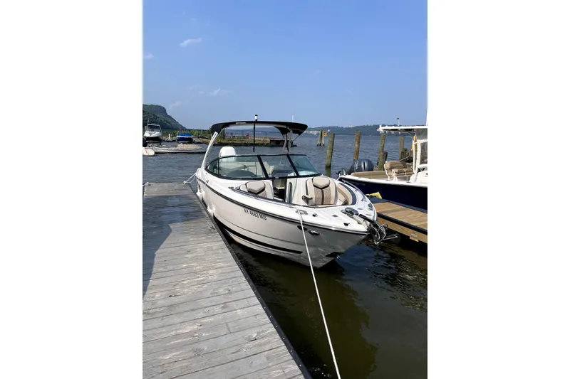 Slide: The Image of 2023 Monterey 275SS Super Sport boat docked at a marina on a sunny day. - 10