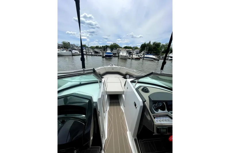 Slide: The Image of 2023 Monterey 275SS Super Sport boat interior with marina view, featuring sleek design and modern controls. - 8