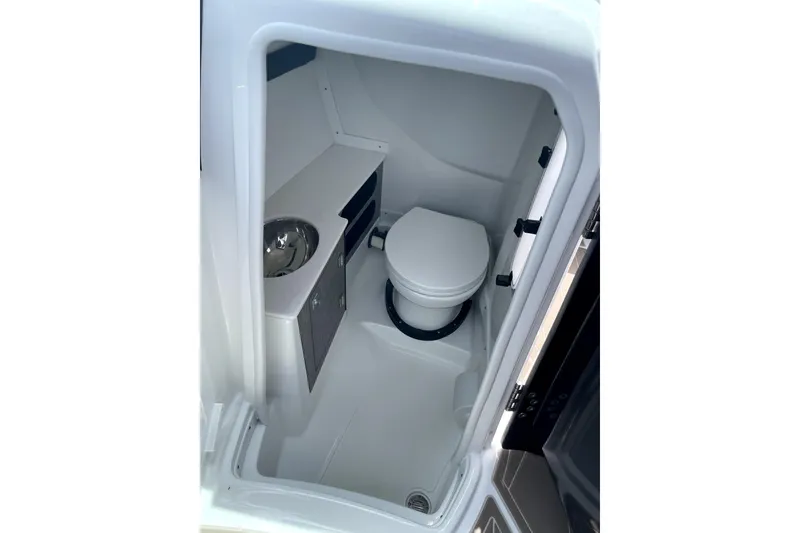 Slide: The Image of 2023 Monterey 275SS Super Sport boat bathroom with toilet and sink. - 9