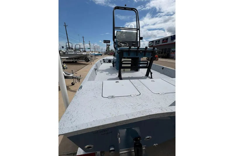 Slide: The Image of 2026 Freedom Boats 21' Commander on display at a dealership under a clear sky. - 12