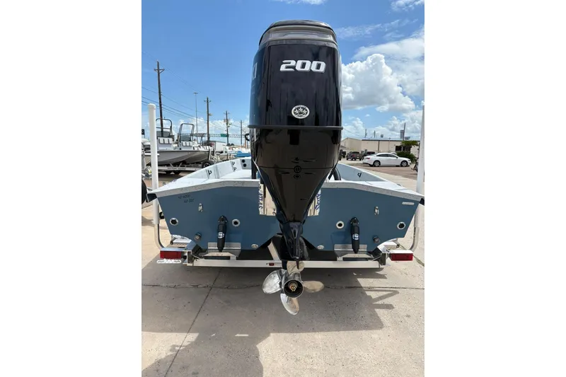 Slide: The Image of 2026 Freedom Boats 21' Commander with powerful 200 HP engine, rear view. - 13