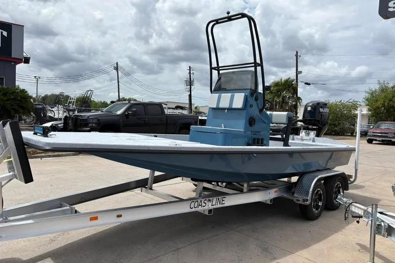 Slide: The Image of 2026 Freedom Boats 21' Commander on trailer, parked outdoors under cloudy sky. - 16