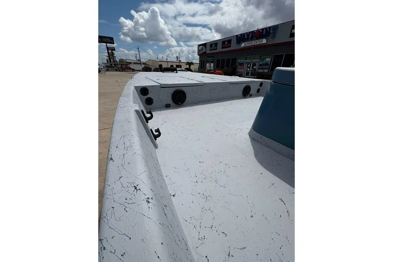 Slide: The Image of 2026 Freedom Boats 21' Commander, white deck, outdoor display, cloudy sky background. - 11