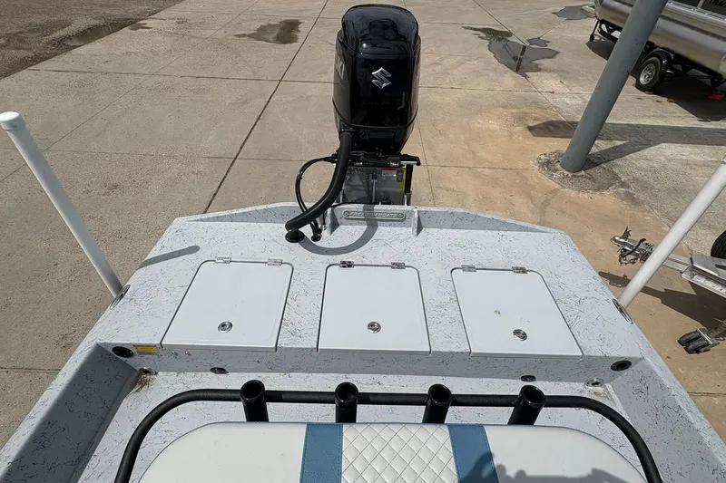 Slide: The Image of 2026 Freedom Boats 21' Commander with Suzuki outboard motor, docked on concrete surface. - 4