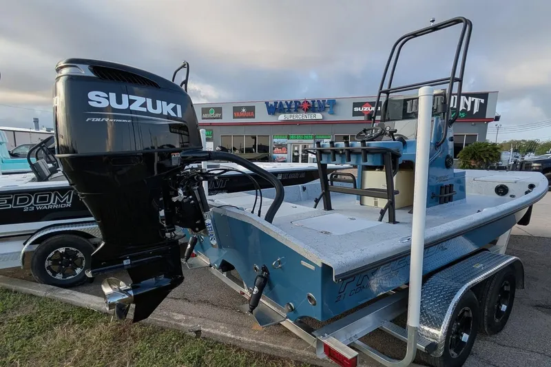 Slide: The Image of 2026 Freedom Boats 21' Commander with Suzuki engine at dealership. - 6