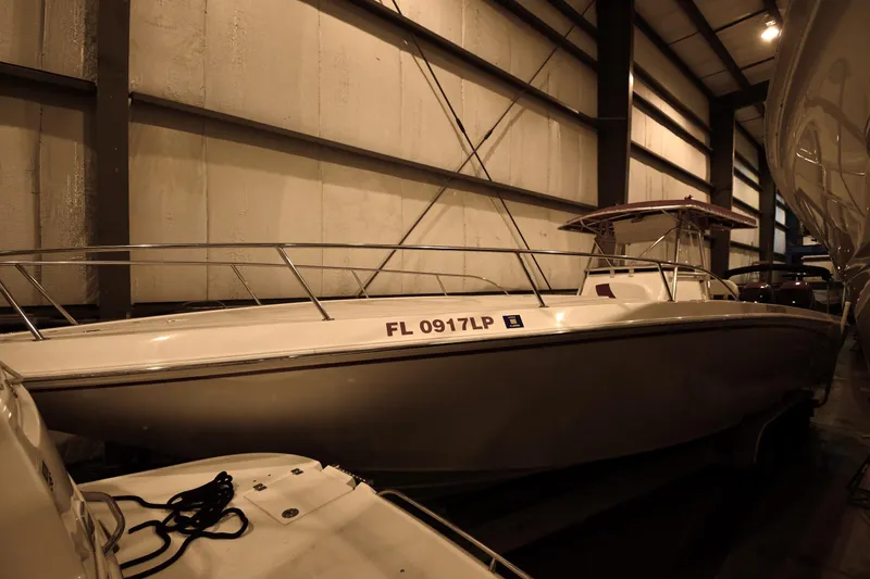 The Image of 2001 Fountain 38 Center Console boat with triple Mercury Verado engines on a trailer. - 0