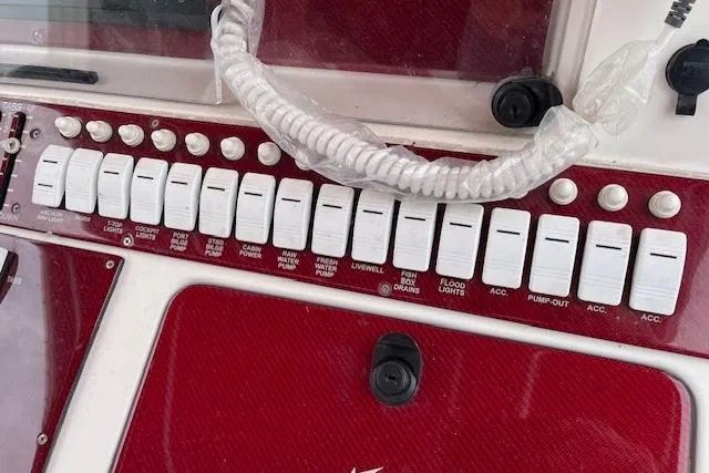 Slide: The Image of Control panel of a 2001 Fountain 38 Center Console boat with labeled switches. - 12