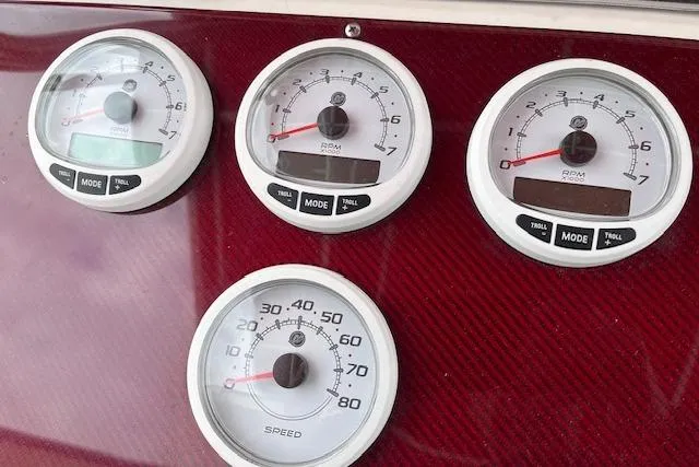 Slide: The Image of Instrument panel of 2001 Fountain 38 Center Console with RPM and speed gauges. - 14