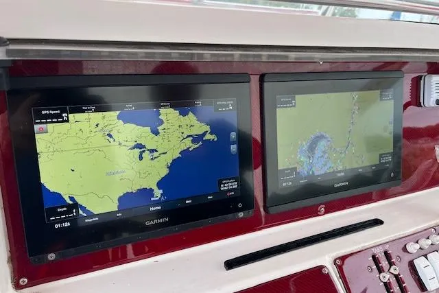 Slide: The Image of Garmin navigation screens on a 2001 Fountain 38 Center Console boat dashboard. - 15