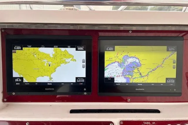 Slide: The Image of Dual Garmin navigation screens on a 2001 Fountain 38 Center Console boat dashboard. - 16