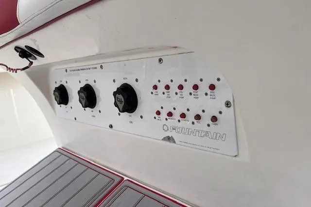 Slide: The Image of Control panel of a 2001 Fountain 38 Center Console boat with switches and dials. - 18