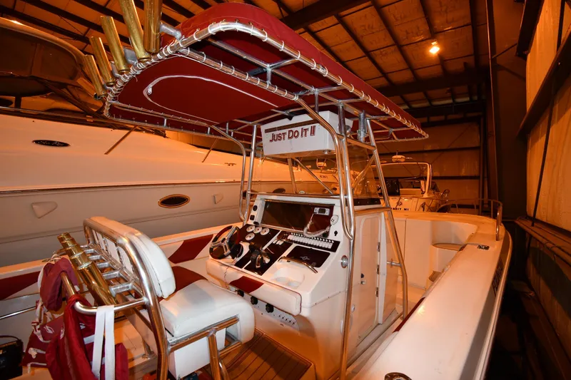 Slide: The Image of 2001 Fountain 38 Center Console boat stored indoors, side view. - 2