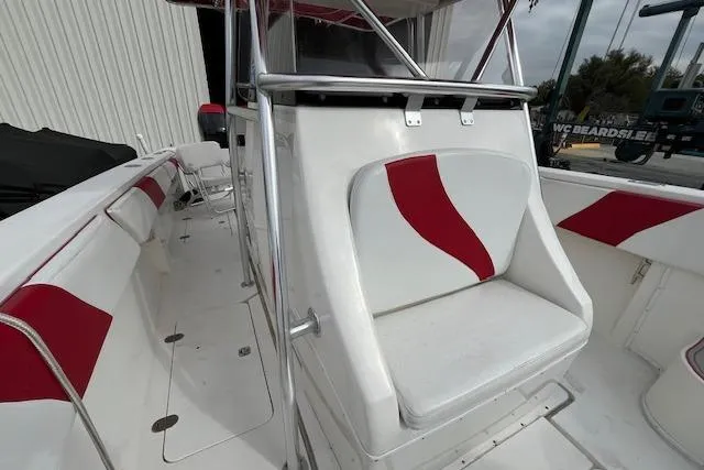 Slide: The Image of 2001 Fountain 38 Center Console boat with red and white seating, docked outdoors. - 20