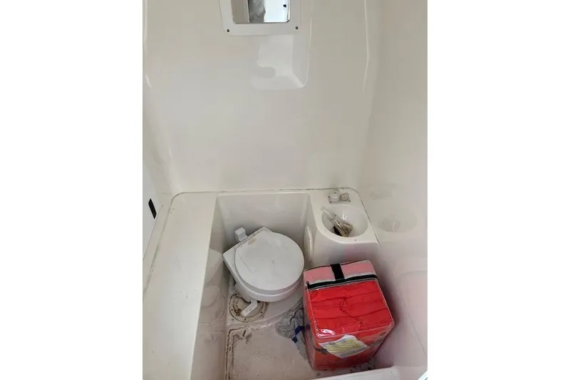 Slide: The Image of 2001 Fountain 38 Center Console boat interior with toilet and storage area. - 21