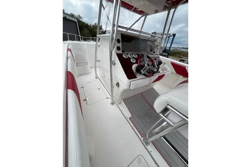 Slide: The Image of 2001 Fountain 38 Center Console boat interior with red and white seating and control panel. - 25