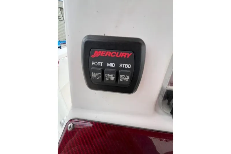 Slide: The Image of Control panel of a 2001 Fountain 38 Center Console boat with Mercury start/stop buttons. - 26