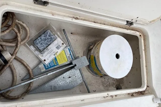 Slide: The Image of Storage compartment of 2001 Fountain 38 Center Console with anchor and rope. - 31