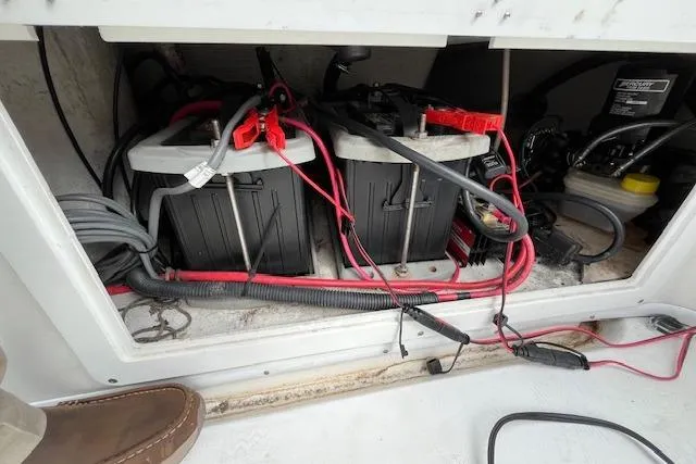 Slide: The Image of 2001 Fountain 38 Center Console battery compartment with wiring and connections. - 32