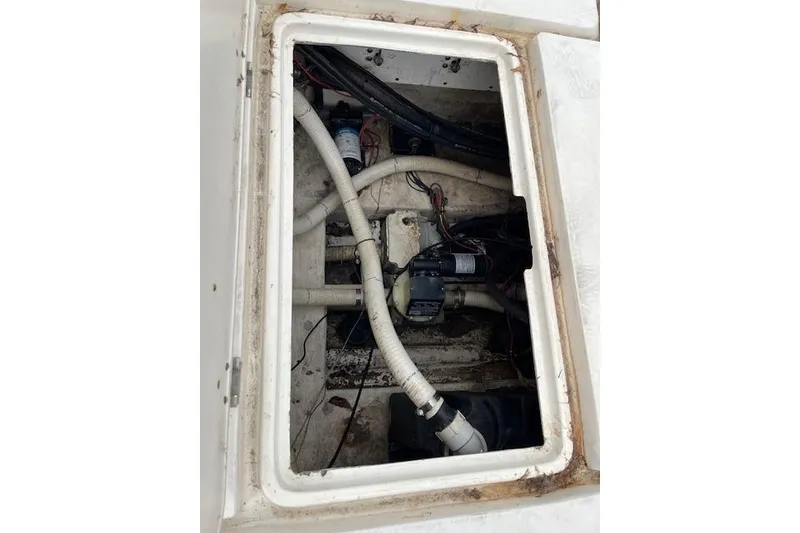 Slide: The Image of Bilge area of a 2001 Fountain 38 Center Console boat, showing pipes and wiring. - 33