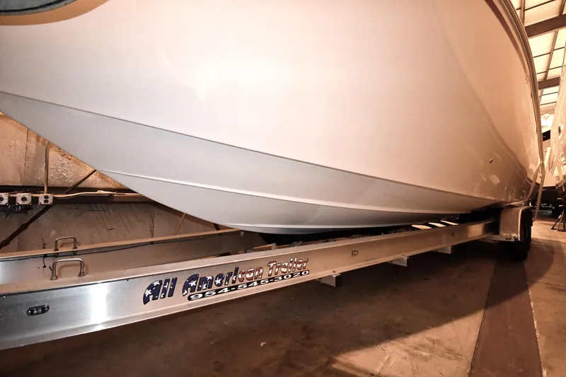 Slide: The Image of 2001 Fountain 38 Center Console boat on trailer in indoor storage. - 34
