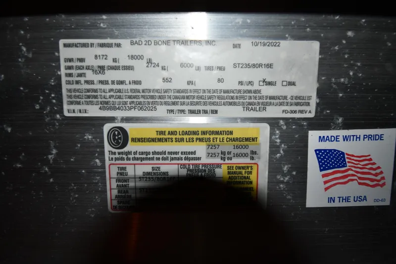 Slide: The Image of Trailer information labels with tire and loading details, featuring an American flag sticker. - 38