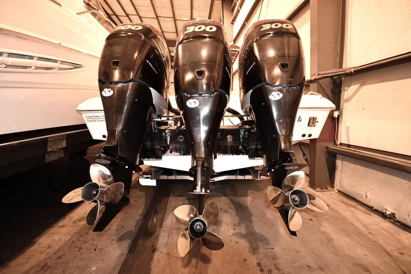Slide: The Image of Triple outboard engines on a 2001 Fountain 38 Center Console boat in storage. - 39
