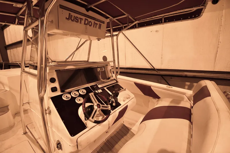 Slide: The Image of 2001 Fountain 38 Center Console boat interior with steering wheel and seating. - 44