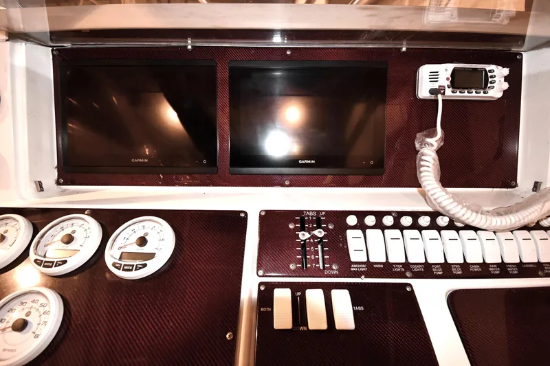 Slide: The Image of 2001 Fountain 38 Center Console dashboard with Garmin displays and control switches. - 45