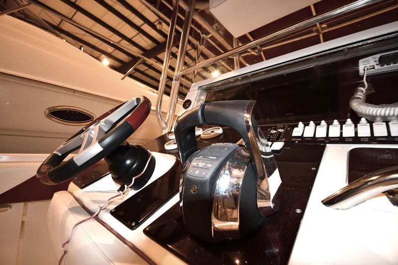 Slide: The Image of 2001 Fountain 38 Center Console boat dashboard with steering wheel and controls. - 46