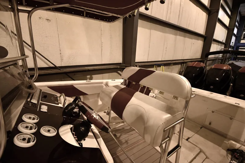 Slide: The Image of 2001 Fountain 38 Center Console boat interior with steering wheel and seating. - 47
