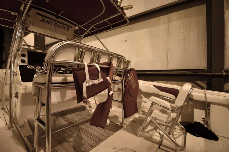 Slide: The Image of 2001 Fountain 38 Center Console boat interior with life jackets and seating. - 48