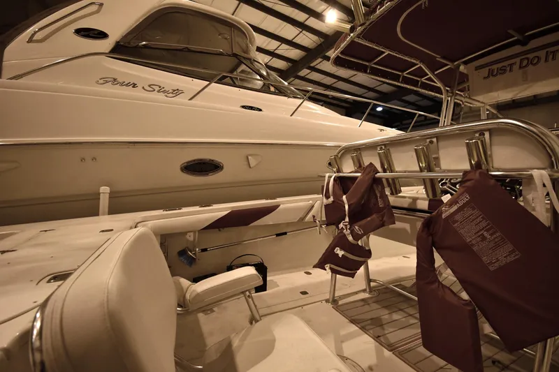 Slide: The Image of 2001 Fountain 38 Center Console boat in storage, featuring life jackets and seating. - 49